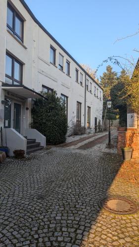 a cobblestone street in front of a white building at Kastanienbaum in Herzogenaurach