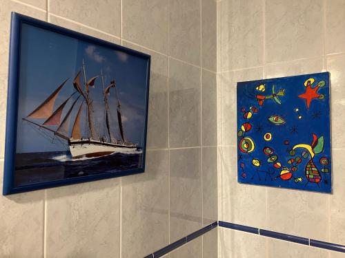a painting of a ship on a wall with a picture at Admirals Suite, Gibraltar in Gibraltar