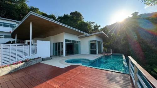 a house with a swimming pool in the backyard at PapaCrab Boutique Guesthouse in Kamala Beach