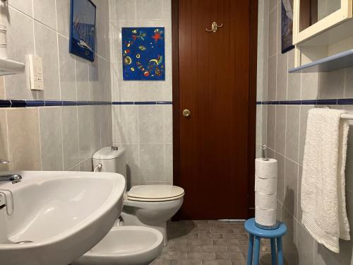 a bathroom with a white toilet and a sink at Admirals Suite, Gibraltar in Gibraltar