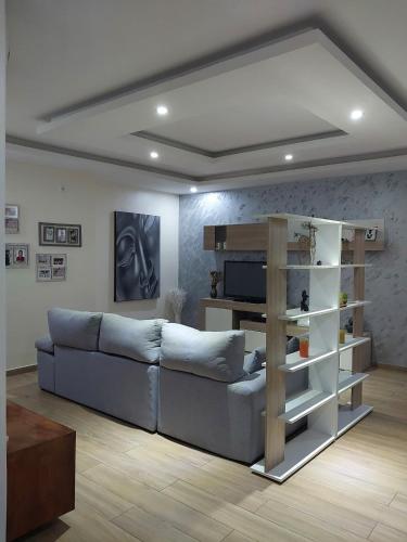 a living room with a blue couch and a shelf at House for rent in Malabo - Equatorial Guinea in Ciudad de Malabo