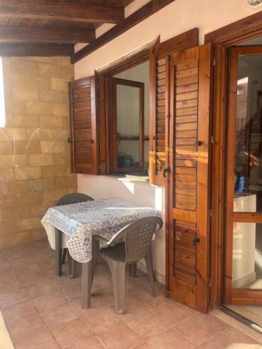 a table and chairs in a room with a mirror at Appartamento nel cuore di Lampedusa in Lampedusa