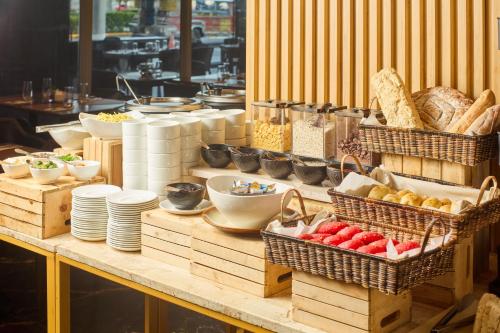 a buffet with baskets of food on a table at Summit Hotel Tacloban in Tacloban