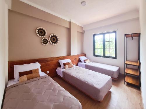 Postel nebo postele na pokoji v ubytování Ocean Beach Villas - Carita Kondominium