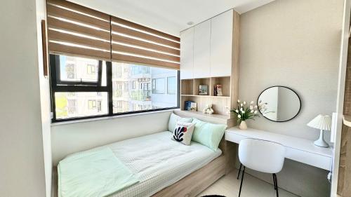 a small bedroom with a bed and a window at Châu Giang Homestay, Nera Garden Huế in Thôn Văn Dương