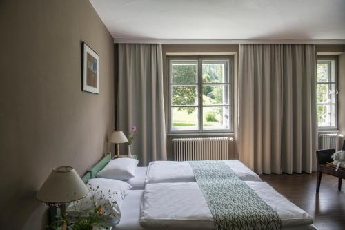 a hotel room with two beds and a window at Hotel Tre Cime Sesto - Sexten in Sesto