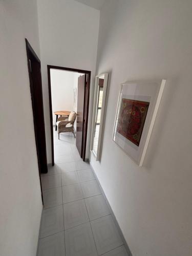 a hallway leading to a room with a table at Mira-mar in Odeceixe