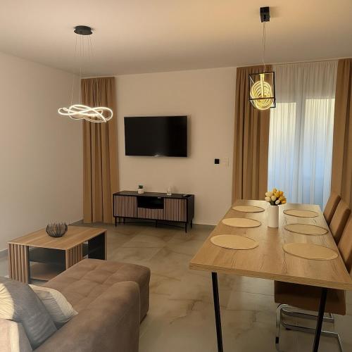 a living room with a table and a couch at Pet-house in Trstice
