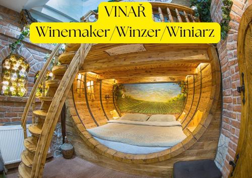 a room with a bed inside of a wooden tunnel at Hotel Kocourkov in Hlinsko