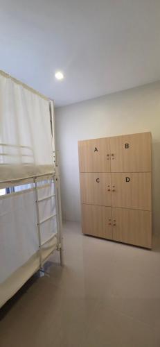 a room with two bunk beds and two wooden cabinets at Cozypod Rentals in Sagcahan