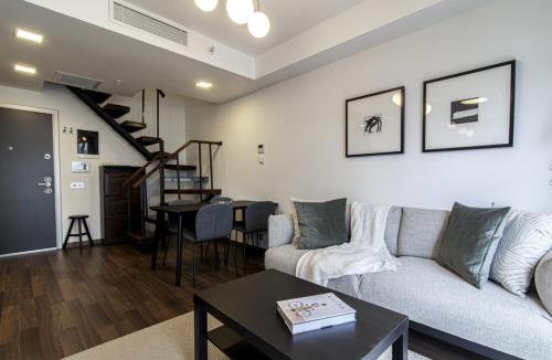 a living room with a couch and a table at Charming 1BR Stone House with Lake View in Bogazici