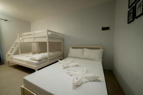a bedroom with two beds and a bunk bed at Cozypod Rentals in Sagcahan
