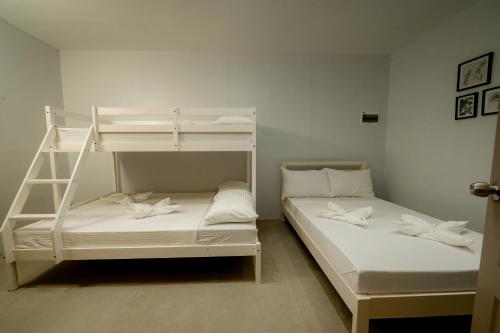 a bedroom with two bunk beds and a ladder at Cozypod Rentals in Sagcahan
