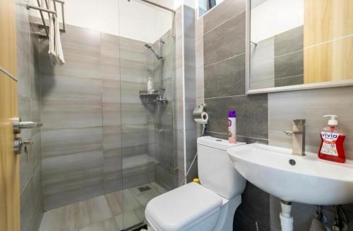 a bathroom with a toilet and a sink at Rieyo Homes Studio near Airport and SGR Train Station in Nairobi