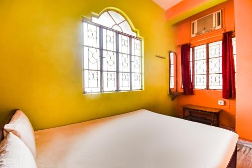 a bedroom with a bed and a window at Hotel O Roshan in Āsansol
