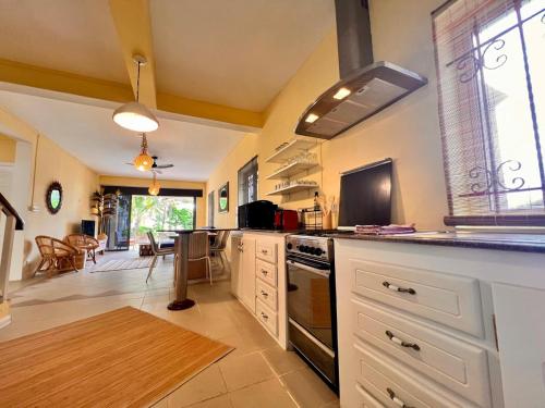 a kitchen with white cabinets and a counter top at Beach Villa Coco in Palmar