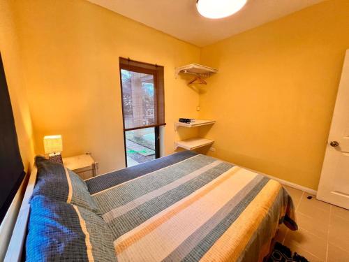 a bedroom with a bed and a window at Beach Villa Coco in Palmar