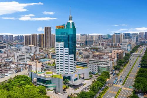 an aerial view of a city with a tall skyscraper at Hotel Silverland in Dongguan