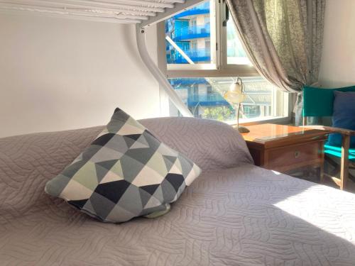 a bedroom with a bed with a pillow and a window at Admirals Suite, Gibraltar in Gibraltar