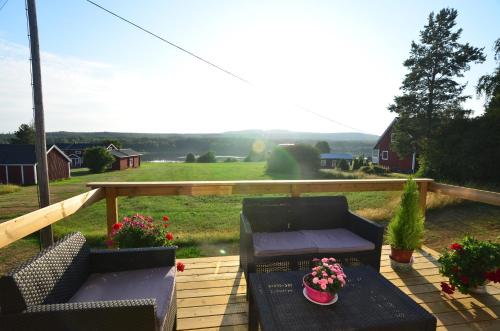 a patio with two chairs and a table with flowers at Villa Sisu in Överkalix