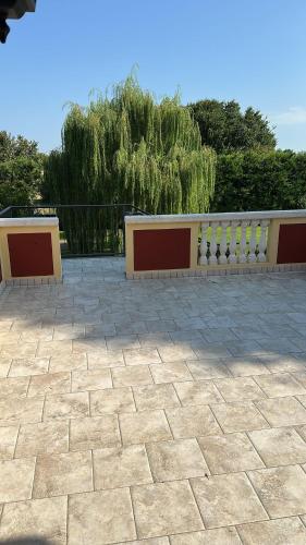 two benches on a patio with a fence at Osteria Locanda Veneta in Mirano