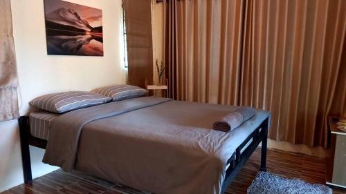 a bed with two pillows on it in a bedroom at Phu Pha View Doi in Samoeng