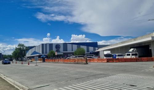 a parking lot in front of a large building at SMDC PARK RESIDENCE SM City Santa Rosa, Laguna in Ibaba