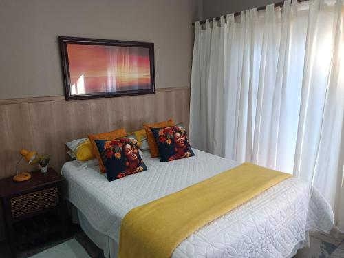 a bedroom with a bed with two pillows on it at Sarah's Place Guesthouse in Pretoria