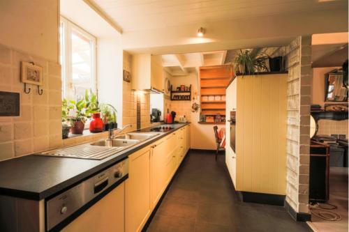 a large kitchen with a sink and a refrigerator at De Groene Hoeve in Brakel