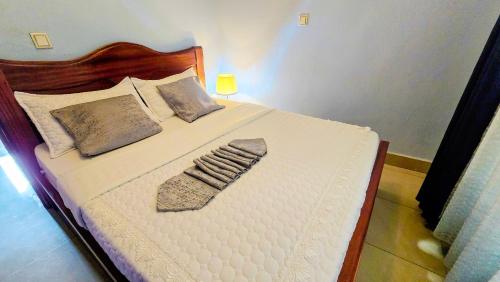 a bed with a pillow and a sock on it at Gravity Suites in Taba