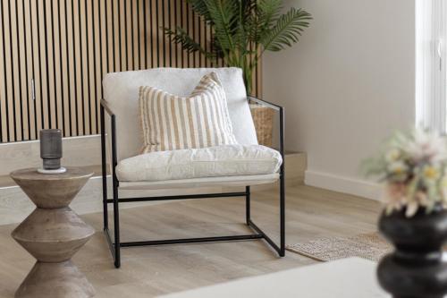 a chair with a pillow in a living room at The Coastal Retreat Two-unit Oasis in Shoalwater