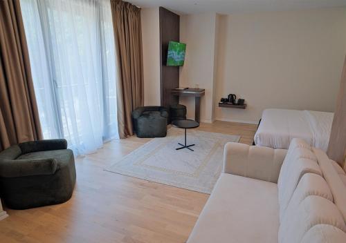 a living room with a couch and a chair at Hotel Valbor in Tropojë