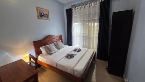 a bedroom with a bed with two glasses on it at Gravity Suites in Taba