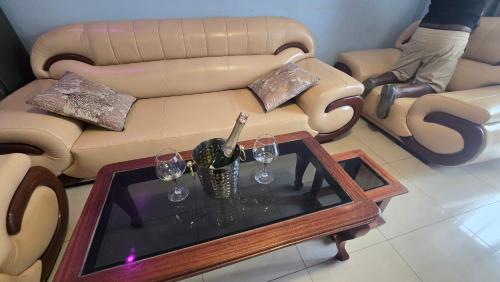 a living room with a couch and a table with wine glasses at Gravity Suites in Taba