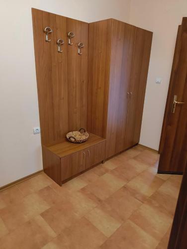 a large wooden cabinet with a dog sleeping in it at Evrika home 4 in Pamporovo