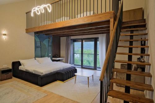 a bedroom with a loft bed and a staircase at Hotel Valbor in Tropojë