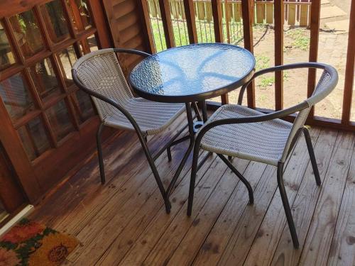 a table and two chairs on a porch at Sarah's Place Guesthouse in Pretoria
