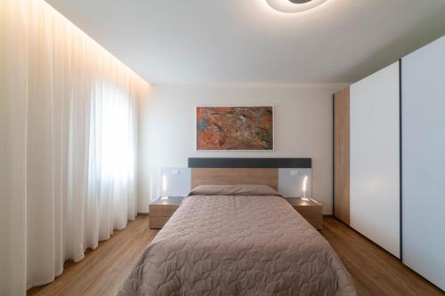 Ένα ή περισσότερα κρεβάτια σε δωμάτιο στο EnJoy Home - Appartamento Cielo - Il Canterale