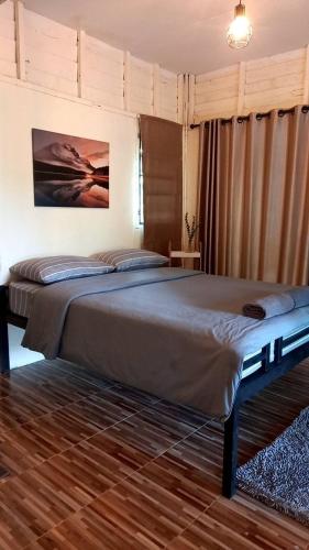 a bedroom with a large bed in a room at Phu Pha View Doi in Samoeng