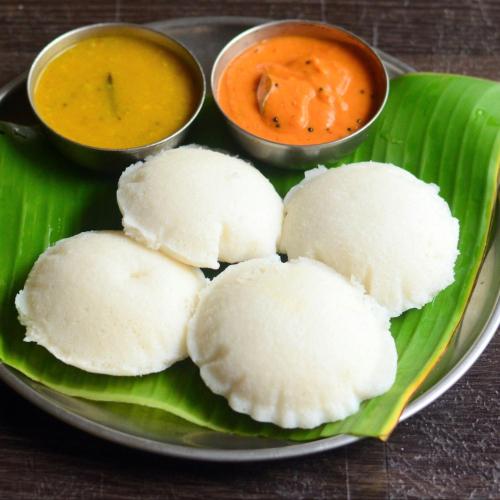 a plate of food with two bowls of dipping sauces at Seethavanam Farmstay at Forest Edge in Kollengode