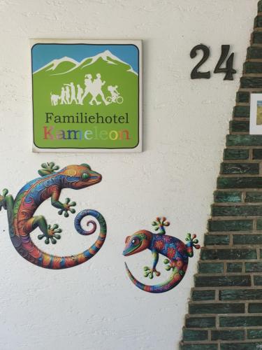 a sign for a farm inhabited kamachi with two snakes at Famile Hotel Kameleon in Olsberg