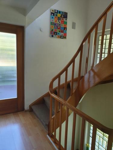 a staircase in a home with a wooden stair case at Famile Hotel Kameleon in Olsberg