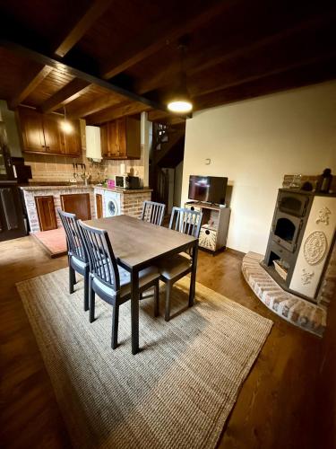 a kitchen with a table and chairs in a room at La Casería de Los Hevia 1 y 2 in Arriondas