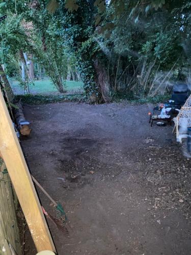 a dirt parking lot with a fence and trees at Perk25A in Steenokkerzeel