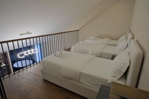 two beds in a hotel room with a balcony at Hotel Valbor in Tropojë