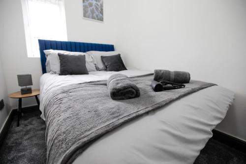 a white bed with a blanket and pillows on it at Dixon House, Sleeps 6, Free Parking, Long or Short Stays - by NMB Property in Horwich