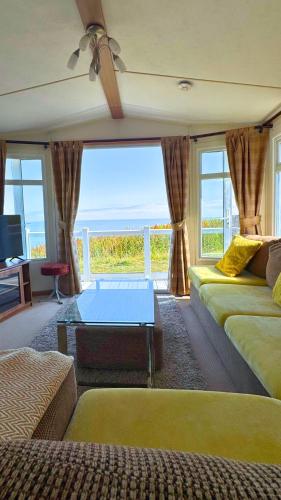 a room with two beds and a view of the ocean at Anchor's Drop in Blue Anchor
