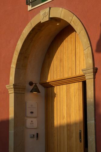 an arched wooden door in a building at Casa di Nonno in Serdiana