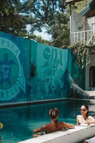 two people in the swimming pool at a resort at Tipsea Turtle Gili Air in Gili Air