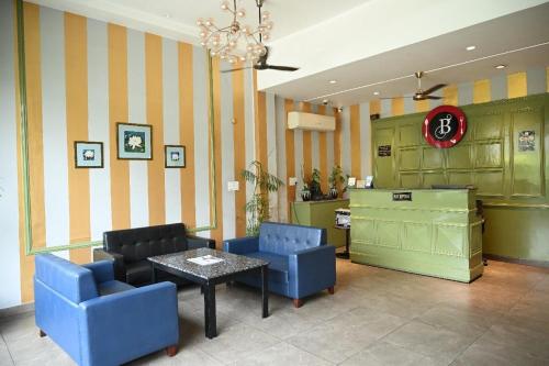a waiting room with chairs and a table in a store at Hotel Golden Fern in Patiāla